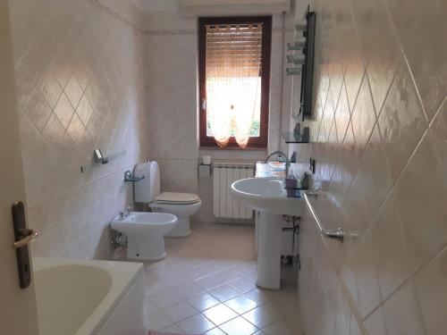 a bathroom with a sink and a toilet and a tub at Caterina in Marina di Massa