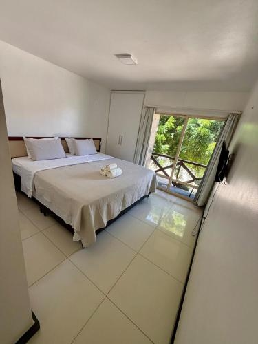a bedroom with a bed and a large window at ECO PARADISE -Apt 212 in Caucaia