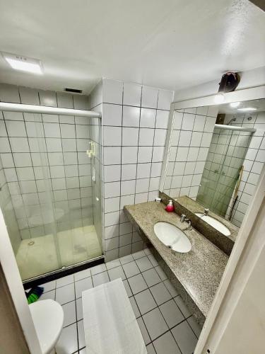 a bathroom with a toilet and a sink and a mirror at ECO PARADISE -Apt 212 in Caucaia