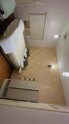 a room with a bed and a desk in it at شاليه in Al Bukayriyah