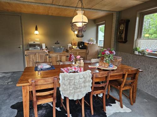 a wooden dining room table and chairs in a kitchen at B&B Koe en Kussen in Bodegraven