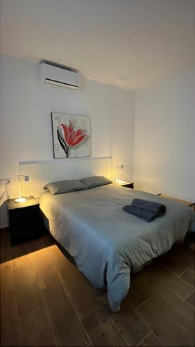 a bedroom with a large white bed with two lamps at Villa Karma in Berja