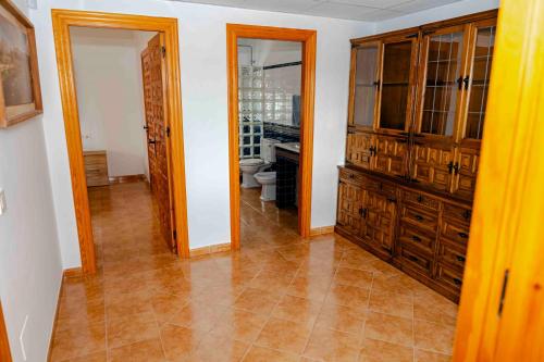 a room with a toilet and wooden cabinets at Cortijo Cristea in Cehegín