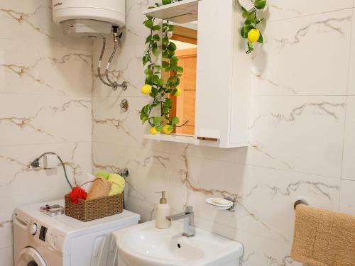 a bathroom with a sink and a toilet and a mirror at Apartman Boki in Bileća