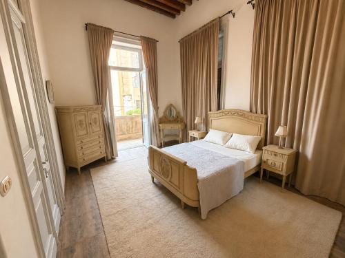 a bedroom with a bed and a large window at 7 Heaven in Alexandria