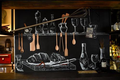 a black wall with utensils and a plate of food at Euro Hotel Grivita in Bucharest