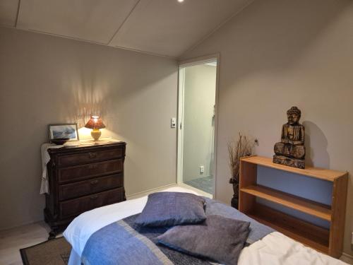 a bedroom with a bed and a dresser and a mirror at Utleiebolig Fannrem in Fannrem