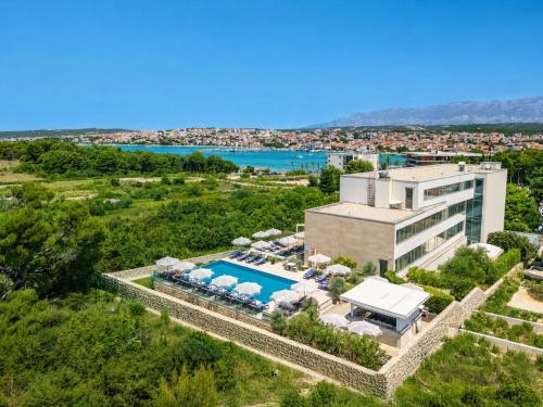 an aerial view of a resort with a swimming pool at Hotel Joel in Novalja