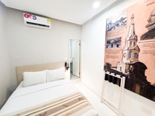 a room with a bed and a poster on the wall at Hotel Gallery Cartagena in Cartagena de Indias
