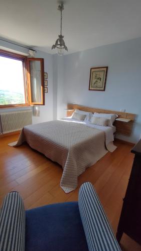 a bedroom with a large bed and a window at Ciliano 16 in Montepulciano