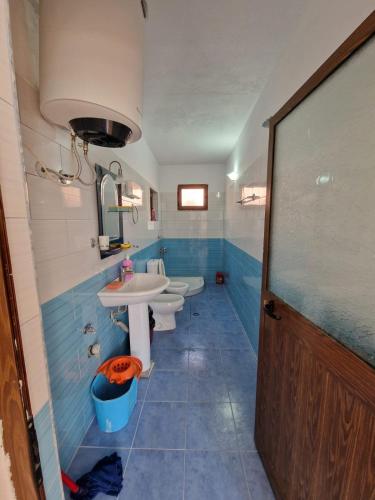 a bathroom with a sink and two toilets in it at Bujtina Dalmacia in Shkodër