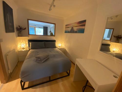a small bedroom with a bed and a table at Apt 2 Cathedral & River view in Norwich
