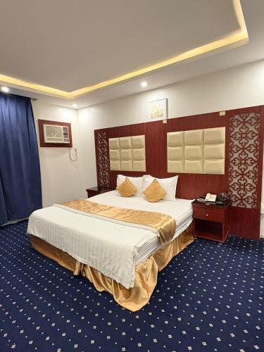 a bedroom with a large bed in a room at Asus Al Taj Serviced Apartments in Baish