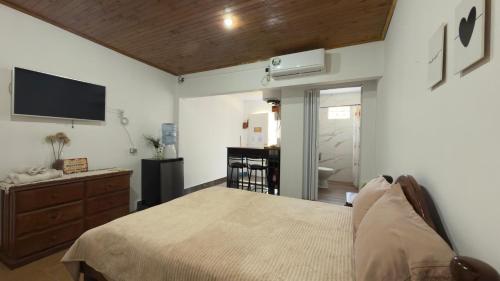 a bedroom with a bed and a flat screen tv at APART LyM 1 in Clorinda