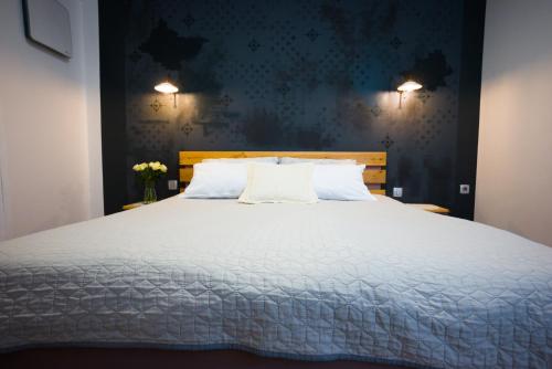 a bedroom with a large white bed with two pillows at FRIZ&FANY Charm House in Postojna