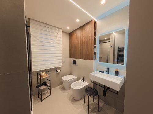 a bathroom with a white toilet and a sink at Loft 26 Apartment in Caltanissetta