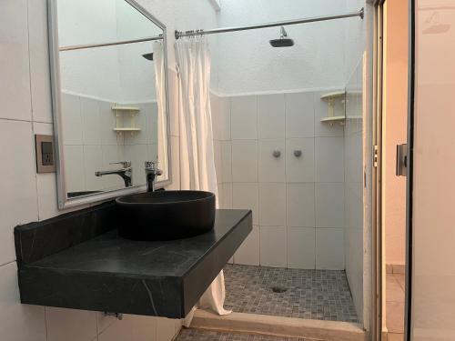 a bathroom with a black sink and a shower at Hotel Mare in Santa Maria Huatulco