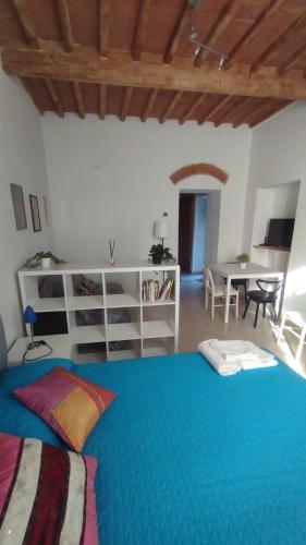 a bedroom with a blue bed and a table at Dimora toscana in Santa Maria del Giudice