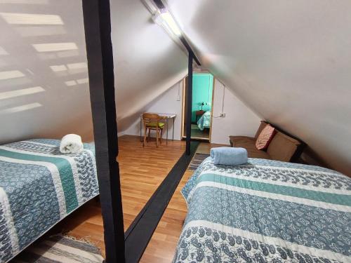 a room with two beds and a couch at Kramm House Aldea 47 in Coihaique