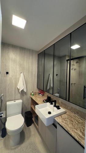 a bathroom with a white toilet and a sink at Premium Suite - Perdizes - Luxury & Panoramic View in São Paulo