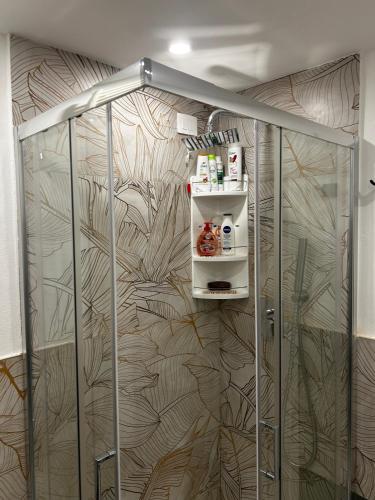 a shower stall in a room with a wall at Seroa 1 in San Bernardino