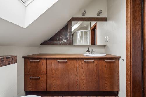 a bathroom with a sink and a staircase at Willa Horyzont in Hel