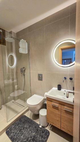 a bathroom with a toilet sink and a shower at Angelo’s Elegant Summer House in Possidi