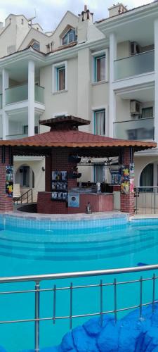 a hotel with a swimming pool in front of a building at Rayon Apart hotel in Marmaris