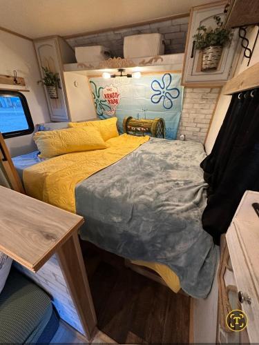 a small bedroom with a bed in a rv at SpongeBob SquarePants on the River in Bullhead City