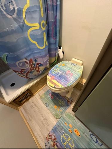 a small bathroom with a toilet and a shower at SpongeBob SquarePants on the River in Bullhead City