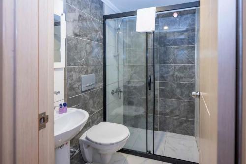 a bathroom with a shower and a toilet and a sink at LEGEND TULIP HOTEL in Antalya