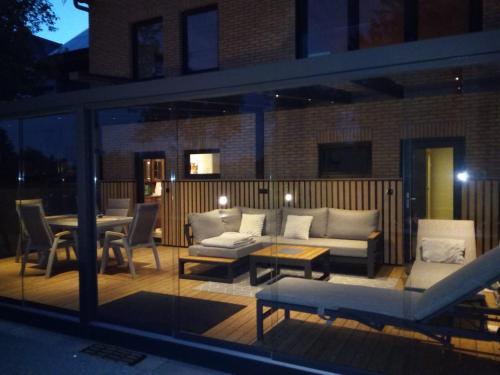 a patio with a couch and a table and chairs at Eifeltraum Marianus in Nieder-Emmels