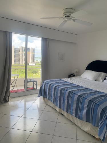 a bedroom with a bed and a large window at Seabreeze suite in Cupe Coy
