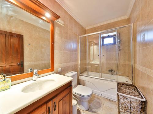 a bathroom with a sink and a toilet and a shower at Villa Defne Kaş in Cukurbag