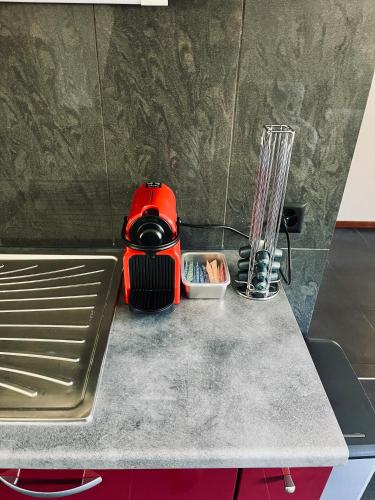 a kitchen counter with a red appliance on it at Le Chalet de la Coudre in Neuchâtel
