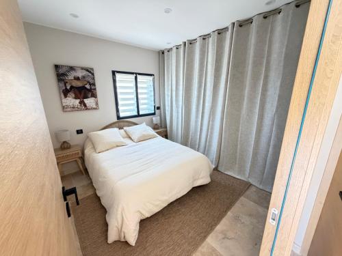a bedroom with a bed and a window at Douce Évasion in Beauvoisin