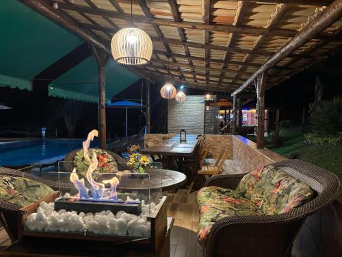 a patio with a table and chairs and a pool at Estação Serramar in Lumiar