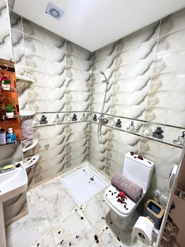 a bathroom with a toilet and a sink at Spacious and Comfortable Apartment in Beni Mellal
