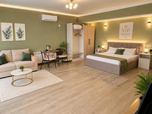 a bedroom with a bed and a living room at Grand Sky Hotel in Almaty