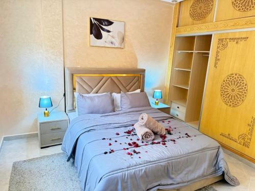 a bedroom with a bed with a stuffed animal on it at Spacious and Comfortable Apartment in Beni Mellal