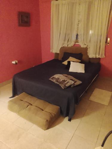 a bedroom with a bed and a window at Fabylu in Ezpeleta