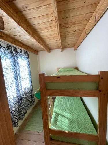 a small room with two bunk beds in it at Cabañas Aires de Campo I in Victoria