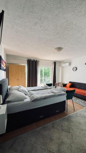 a bedroom with a large bed and a window at Apartments Coko in Omiš