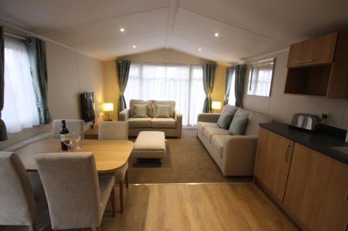 a living room with a couch and a table in a room at The Trotting Mare Holiday Lets - Adults Only in Wrexham