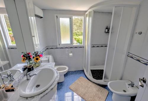 a white bathroom with two sinks and a shower at Casa Carmen e do Hilario in Ponte Do Porto