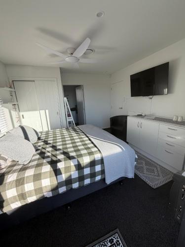 a bedroom with a bed and a ceiling fan at Denbigh Homestay in Midhirst