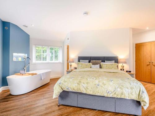 a bedroom with a large bed and a bath tub at 2 Bed in Weymouth oc-75200 in Weymouth