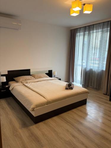 a bedroom with a large bed and a large window at Water House in Shumen