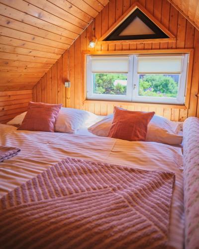 a large bed in a room with a window at vila Barbara - Vysoké Tatry in Stará Lesná