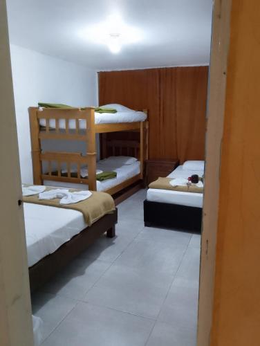 a room with two bunk beds in a room at Alojamiento donde Nur in Filandia